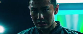 Movie still from “Escape Plan 2: Hades” (2018), directed by Steven C. Miller – A man's face in the dark; Close Up shot, Low angle