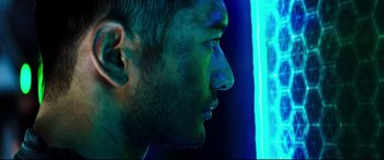 Movie still from “Escape Plan 2: Hades” (2018), directed by Steven C. Miller – A person's face in a dark room; Close Up shot, Low angle