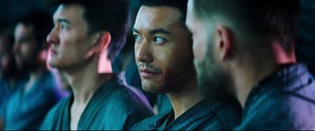 Movie still from “Escape Plan 2: Hades” (2018), directed by Steven C. Miller – A person looking at the camera; Close Up shot, Over the shoulder angle
