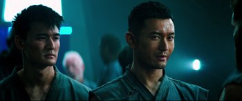 Movie still from “Escape Plan 2: Hades” (2018), directed by Steven C. Miller – A person wearing a black shirt; Close Up shot, Over the shoulder angle