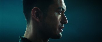 Movie still from “Escape Plan 2: Hades” (2018), directed by Steven C. Miller – A man's face in the dark; Close Up shot, Low angle