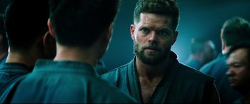 Movie still from “Escape Plan 2: Hades” (2018), directed by Steven C. Miller – A person looking at a mirror; Close Up shot, Over the shoulder angle