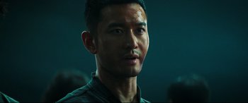 Movie still from “Escape Plan 2: Hades” (2018), directed by Steven C. Miller – A man's face in a dark room; Close Up shot, Over the shoulder angle