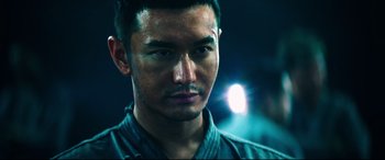 Movie still from “Escape Plan 2: Hades” (2018), directed by Steven C. Miller – A man's face in the dark; Close Up shot, Low angle