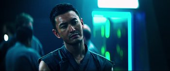 Movie still from “Escape Plan 2: Hades” (2018), directed by Steven C. Miller – A person wearing a black shirt; Close Up shot, Over the shoulder angle