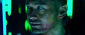 Movie still from “Escape Plan 2: Hades” (2018), directed by Steven C. Miller – A man's face in a green light; Close Up shot, Low angle