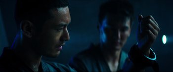 Movie still from “Escape Plan 2: Hades” (2018), directed by Steven C. Miller – Two men sitting in a dark room looking at each other; Close Up shot, Low angle
