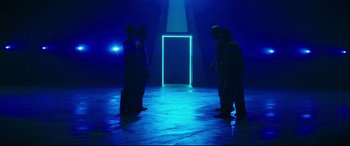 Movie still from “Escape Plan 2: Hades” (2018), directed by Steven C. Miller – A group of men standing in front of an open door; Extreme Wide shot, Low angle