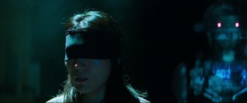 Movie still from “Escape Plan 2: Hades” (2018), directed by Steven C. Miller – A woman with a blindfold on her head; Close Up shot, High angle