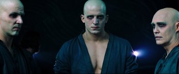 Movie still from “Escape Plan 2: Hades” (2018), directed by Steven C. Miller – A man with a bald head is posing for a picture; Close Up shot, Low angle