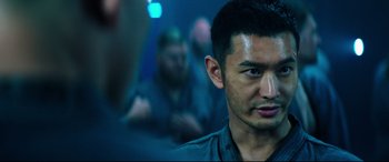 Movie still from “Escape Plan 2: Hades” (2018), directed by Steven C. Miller – A person in a dark room; Close Up shot, Over the shoulder angle