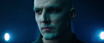 Movie still from “Escape Plan 2: Hades” (2018), directed by Steven C. Miller – A man with a bald head and blue eyes; Close Up shot, Low angle