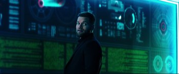 Movie still from “Escape Plan 2: Hades” (2018), directed by Steven C. Miller – A man standing in front of a computer screen; Medium shot, Over the shoulder angle