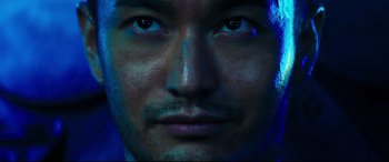 Movie still from “Escape Plan 2: Hades” (2018), directed by Steven C. Miller – A man's face in blue light; Extreme Close Up shot, Low angle