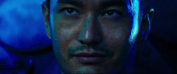 Movie still from “Escape Plan 2: Hades” (2018), directed by Steven C. Miller – A man's face in blue light; Extreme Close Up shot, Low angle