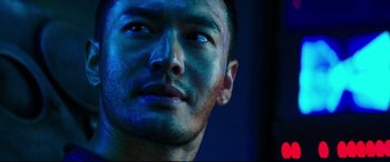 Movie still from “Escape Plan 2: Hades” (2018), directed by Steven C. Miller – A man's face with blue light shining on his face; Close Up shot, Low angle