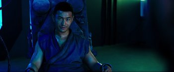 Movie still from “Escape Plan 2: Hades” (2018), directed by Steven C. Miller – A man sitting in a chair in the dark; Medium shot, High angle