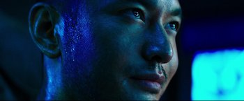 Movie still from “Escape Plan 2: Hades” (2018), directed by Steven C. Miller – A man's face with blue paint on his face; Extreme Close Up shot, Low angle