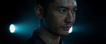 Movie still from “Escape Plan 2: Hades” (2018), directed by Steven C. Miller – A man's face in the dark; Close Up shot, Low angle