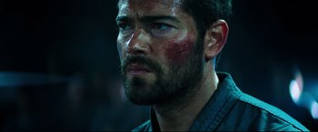 Movie still from “Escape Plan 2: Hades” (2018), directed by Steven C. Miller – A person with a beard; Close Up shot, Over the shoulder angle
