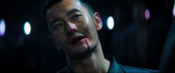 Movie still from “Escape Plan 2: Hades” (2018), directed by Steven C. Miller – A person with blood on his face; Close Up shot, Low angle