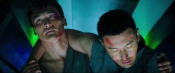 Movie still from “Escape Plan 2: Hades” (2018), directed by Steven C. Miller – Two men with blood on their face and shoulder; Close Up shot, Low angle