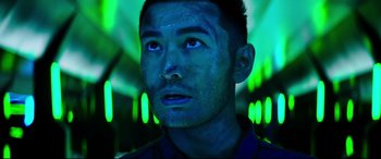 Movie still from “Escape Plan 2: Hades” (2018), directed by Steven C. Miller – A person wearing a black shirt; Close Up shot, Low angle