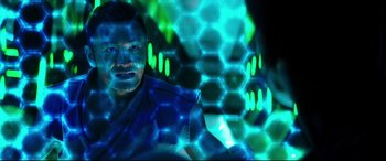 Movie still from “Escape Plan 2: Hades” (2018), directed by Steven C. Miller – A man with blue and green lights in the background; Close Up shot, Low angle
