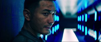 Movie still from “Escape Plan 2: Hades” (2018), directed by Steven C. Miller – A man's face in front of blue lights; Close Up shot, Low angle