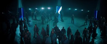 Movie still from “Escape Plan 2: Hades” (2018), directed by Steven C. Miller – A group of people standing in the dark; Extreme Wide shot, High angle