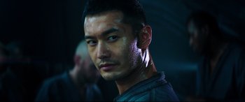 Movie still from “Escape Plan 2: Hades” (2018), directed by Steven C. Miller – A person wearing a jacket; Close Up shot, Low angle