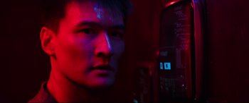 Movie still from “Escape Plan 2: Hades” (2018), directed by Steven C. Miller – A man with a red light in the background; Close Up shot, Low angle