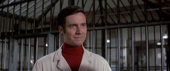 Movie still from “Escape from the Planet of the Apes” (1971), directed by Don Taylor – A man in a white lab coat and a red turtleneck; Close Up shot, Low angle