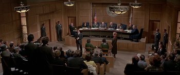Movie still from “Escape from the Planet of the Apes” (1971), directed by Don Taylor – A group of people sitting in front of an audience in a courtroom; Wide shot, High angle