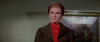 Movie still from “Escape from the Planet of the Apes” (1971), directed by Don Taylor – A person wearing a suit and tie; Close Up shot, Low angle