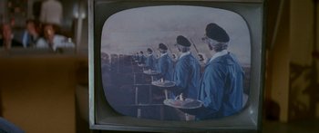 Movie still from “Escape from the Planet of the Apes” (1971), directed by Don Taylor – A group of people standing next to each other holding trays; Extreme Close Up shot, High angle