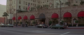 Movie still from “Escape from the Planet of the Apes” (1971), directed by Don Taylor – Cars driving down the street in front of a building; Extreme Wide shot, High angle