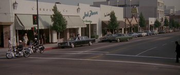 Movie still from “Escape from the Planet of the Apes” (1971), directed by Don Taylor – A couple of cars parked on the side of the street; Extreme Wide shot, High angle