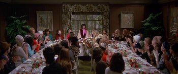 Movie still from “Escape from the Planet of the Apes” (1971), directed by Don Taylor – A group of people sitting around a table with food on top of it; Wide shot, High angle