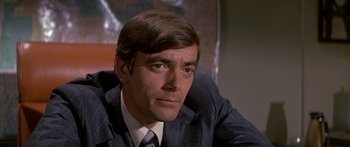 Movie still from “Escape from the Planet of the Apes” (1971), directed by Don Taylor – A person wearing a suit and tie; Close Up shot, High angle