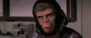 Movie still from “Escape from the Planet of the Apes” (1971), directed by Don Taylor – An ape face in a movie scene; Close Up shot, Over the shoulder angle