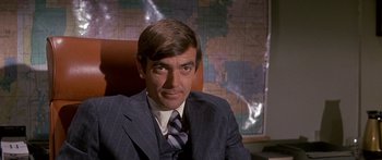 Movie still from “Escape from the Planet of the Apes” (1971), directed by Don Taylor – A person wearing a suit and tie; Close Up shot, High angle