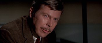 Movie still from “Escape from the Planet of the Apes” (1971), directed by Don Taylor – A person wearing a suit and tie; Close Up shot, Low angle