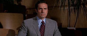 Movie still from “Escape from the Planet of the Apes” (1971), directed by Don Taylor – A man in a gray suit and a red striped tie; Close Up shot, High angle