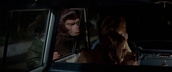 Movie still from “Escape from the Planet of the Apes” (1971), directed by Don Taylor – An ape looking in a mirror in a car; Close Up shot, Over the shoulder angle