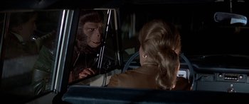 Movie still from “Escape from the Planet of the Apes” (1971), directed by Don Taylor – A woman in the back seat of a car looking into a mirror; Close Up shot, Over the shoulder angle
