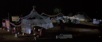Movie still from “Escape from the Planet of the Apes” (1971), directed by Don Taylor – A circus tent is lit up at night with lights; Extreme Wide shot, High angle