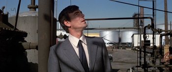 Movie still from “Escape from the Planet of the Apes” (1971), directed by Don Taylor – A man in a suit and tie looking up at the sky; Close Up shot, Low angle