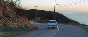 Movie still from “Escape from the Planet of the Apes” (1971), directed by Don Taylor – A van driving down a road with power lines overhead; Extreme Wide shot, High angle