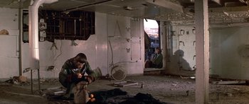 Movie still from “Escape from the Planet of the Apes” (1971), directed by Don Taylor – Two people in an abandoned building looking out a window; Wide shot, High angle